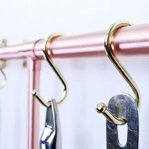 Closeup of hooks holding copper pans