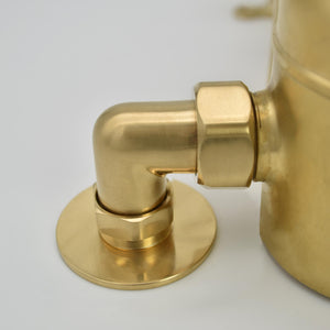 close up photo of a brass shower valve elbow for connection