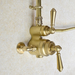 brass thermostatic shower photographed on a marbled tile wall
