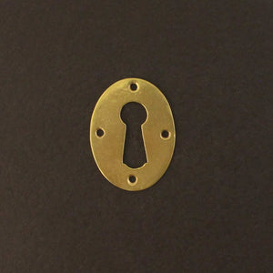 traditional brass escutcheon on black background