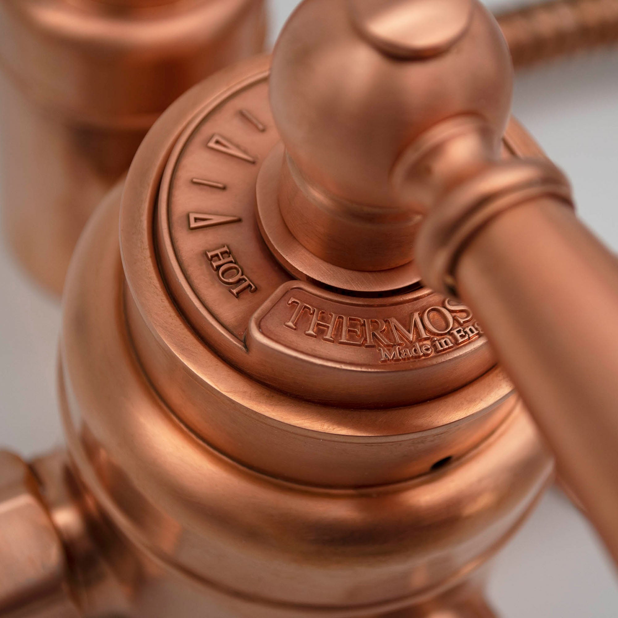made in England logo on a copper thermostatic shower valve