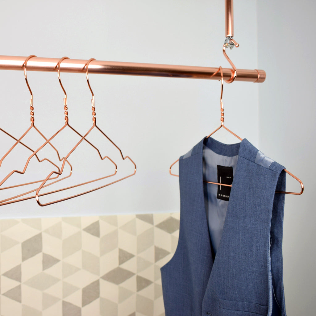 Hanging Copper Clothes Rail with hanging jacket