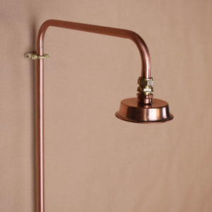 Outdoor shower kit with copper and brass elements showing the copper spout and shower head