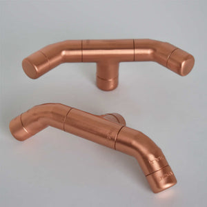 Curved Copper Handle on Plain Background