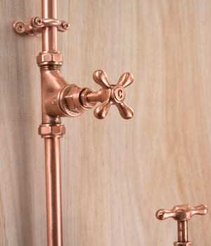 custom cross head copper taps mounted on a unique and stylish outdoor copper shower kit
