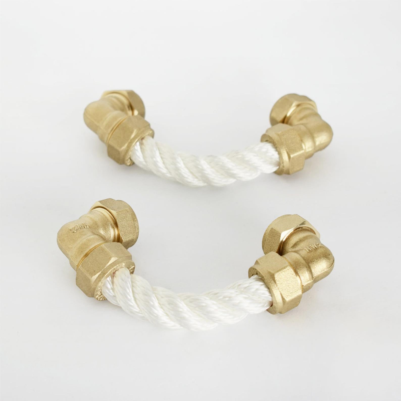 two brass white rope pulls on white background