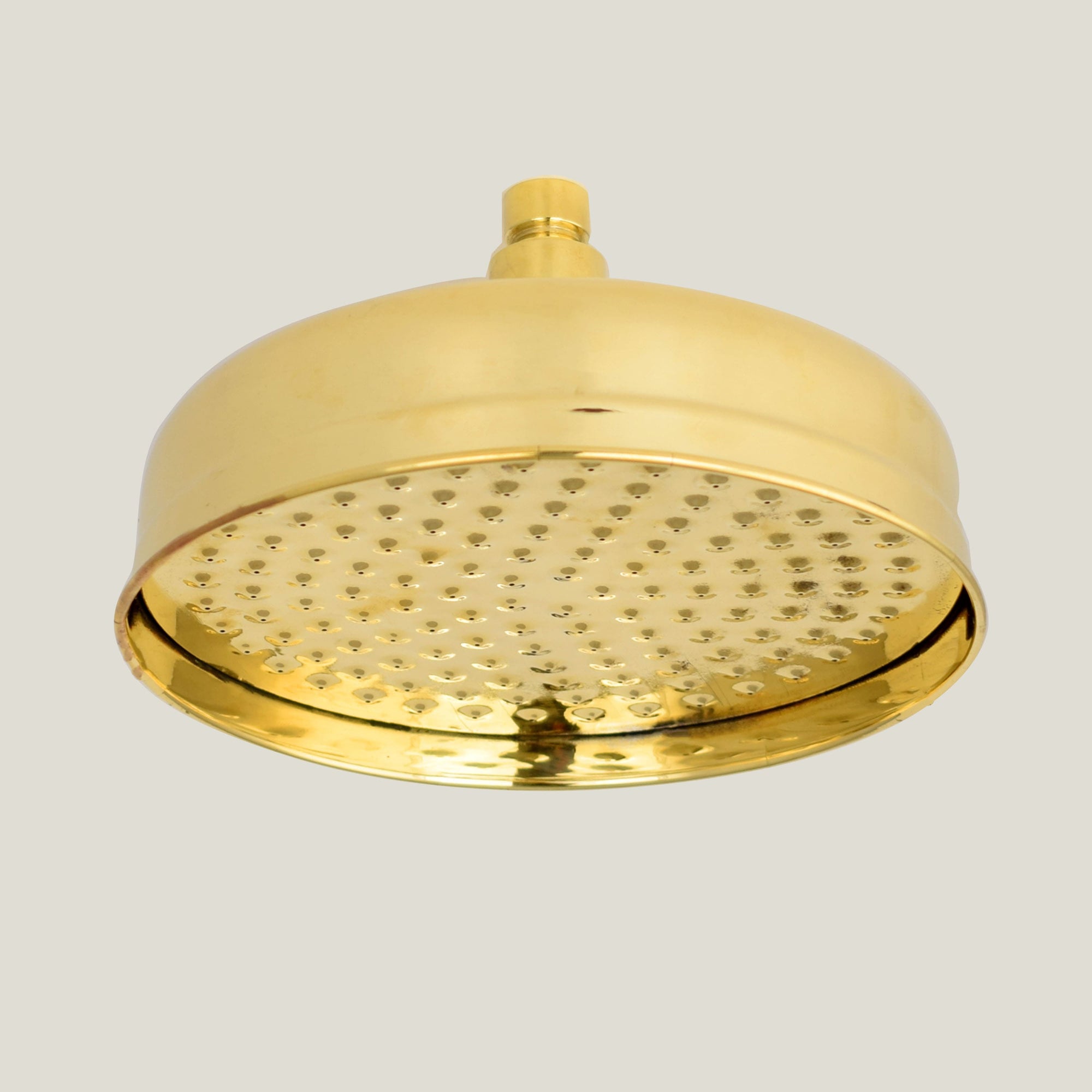 A vintage-inspired brass shower head with a bell-shaped design and a soft rain spray pattern.