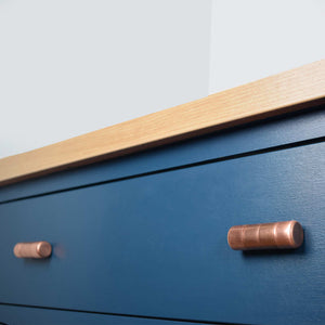 ridged chunky bar knob blue cabinets angled shot