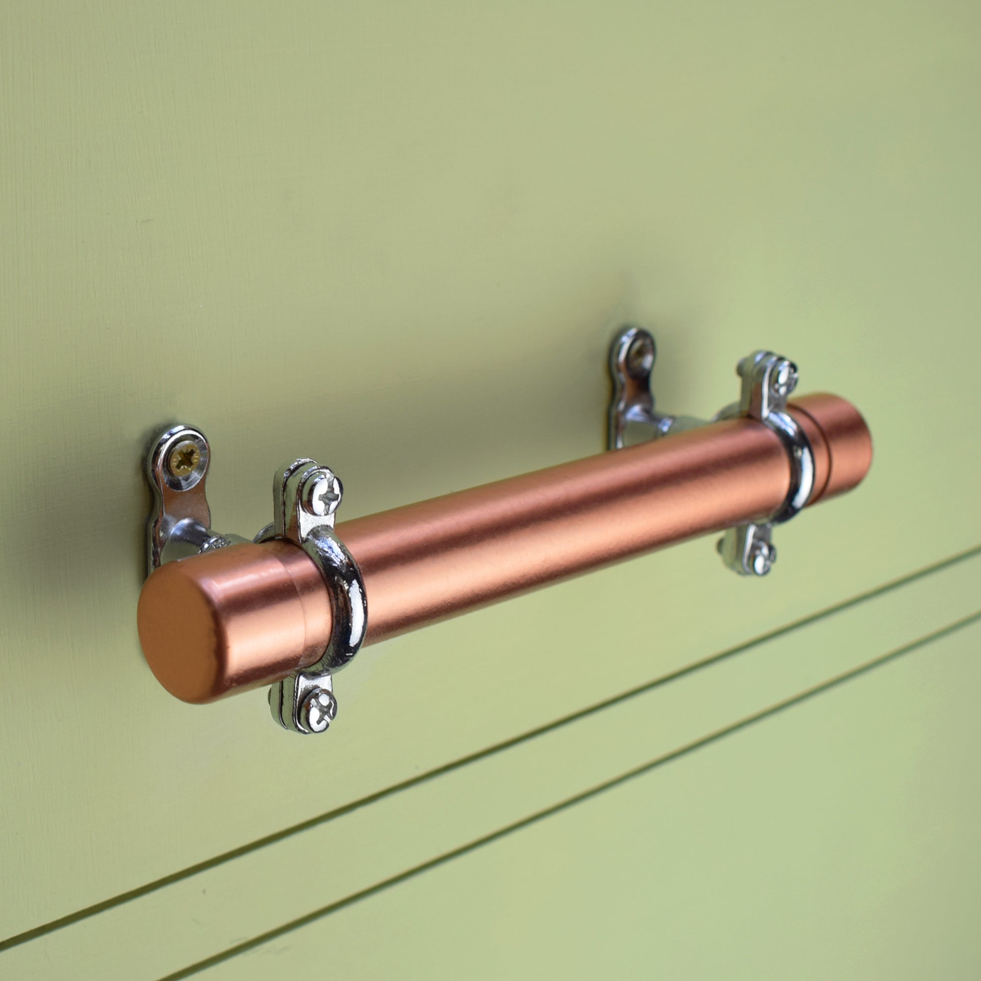 Copper Handle with Chrome Brackets (Thick-bodied) on green drawers - Proper Copper Design