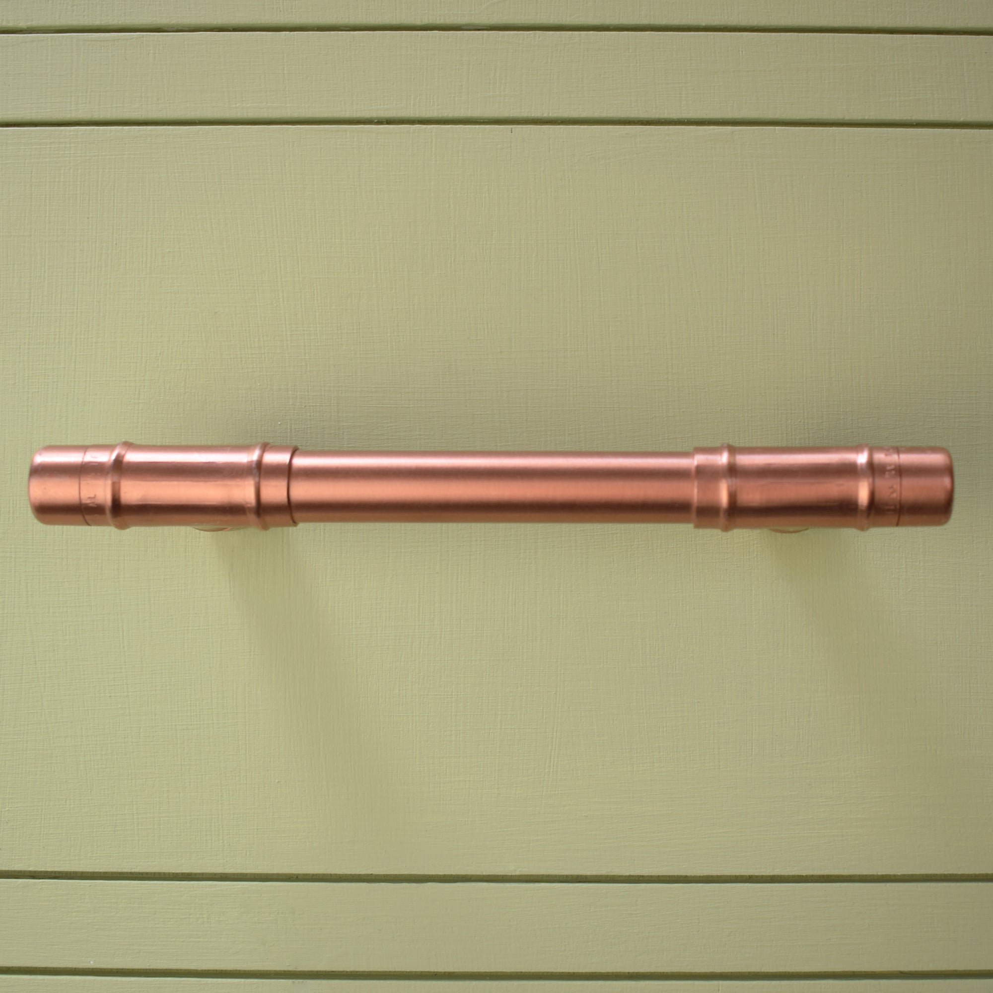Copper Pull Handle T-shaped - Front Shot on Green Cabinet
