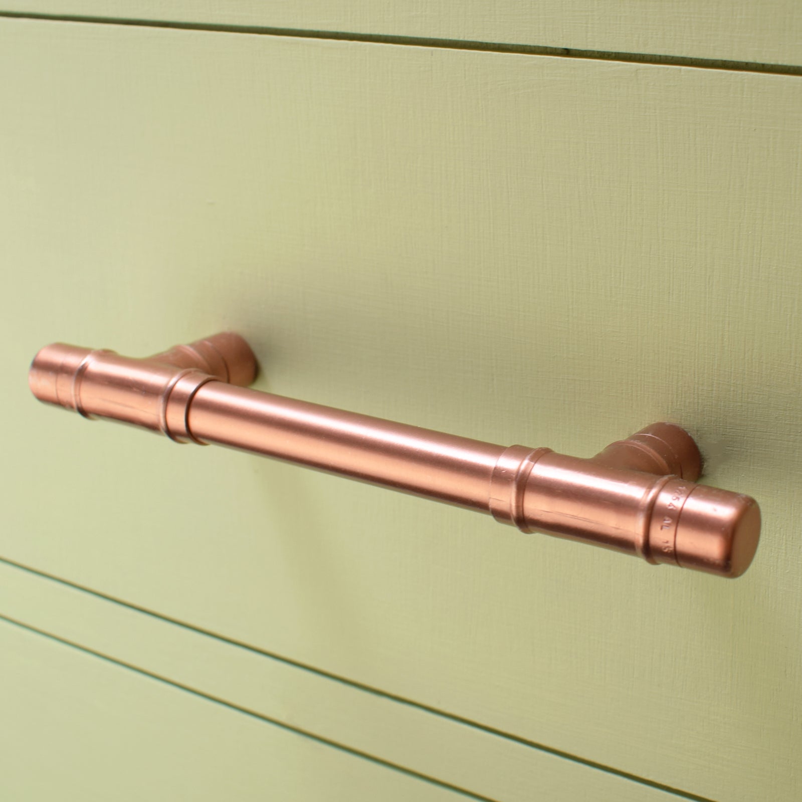 Copper Pull Handle T-shaped - On Green Cabinet