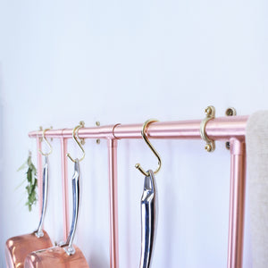 Wall mounted copper pan rack, brass hook closeup